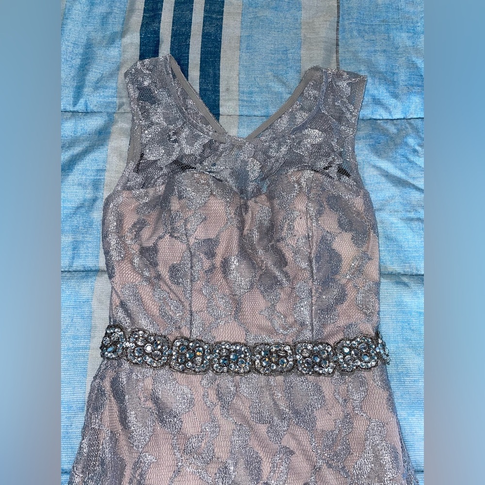 Silver lays on top of nude fabric high slit evening dress